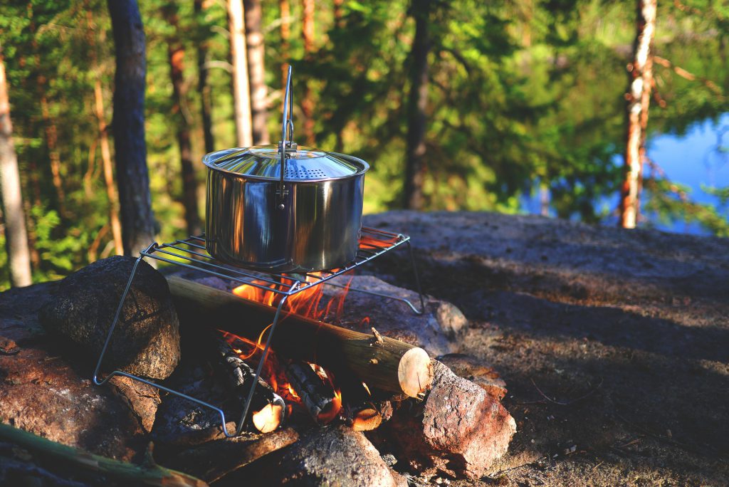 cooking in pot over campfire